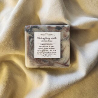 soap bar with swirls of red and black with product label