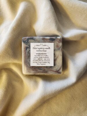 soap bar with swirls of red and black with product label
