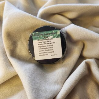 0.9 ounce salve container with product label