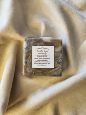 soap bar with swirls of deep red, brown, and black with product label