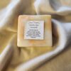 Honeysuckle1 soap bar with swirls of orange and yellow with product label