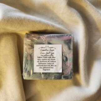 soap bar with swirls of black, teal, and pink with product label