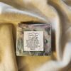 LoveSpell1 soap bar with swirls of black, teal, and pink with product label