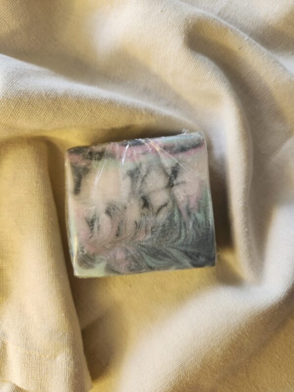 LoveSpell2 soap bar with swirls of black, teal, and pink