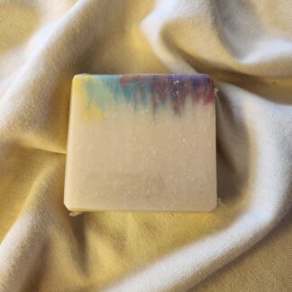 soap bar with splashes of red, purple, blue, and yellow