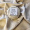 pale colored shampoo bar with product label