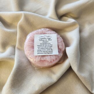 pink shampoo bar with a flower design with product label