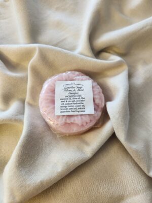 pink shampoo bar with a flower design with product label