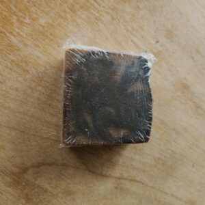 dark brown soap bar with swirls of light brown