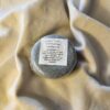 Dark gray soap bar with product label
