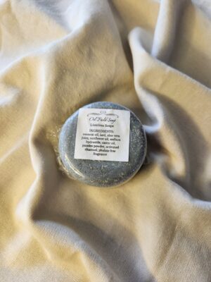 Dark gray soap bar with product label
