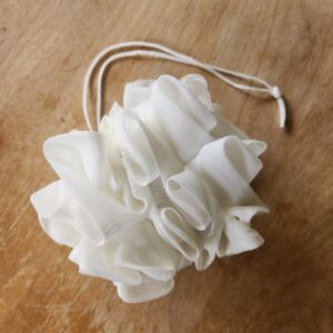 white soap saver luffa in closed position