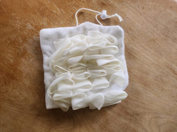 luffa2 white soap saver luffa in open position scrub side out