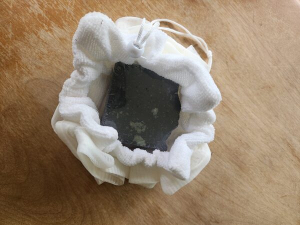 luffa4 white soap saver luffa half opened with soap bar for display purposes